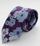 Corbata negra con estampado en flores violetas y celestes